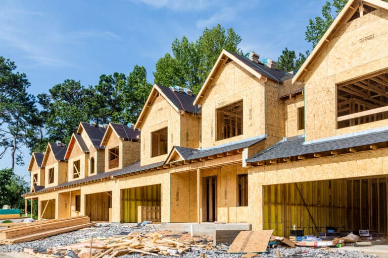 Homebuyer signing documents for GST HST rebate in Ontario | New housing construction eligible for federal tax rebate | Calculator showing GST HST rebate savings for Ontario homebuyers