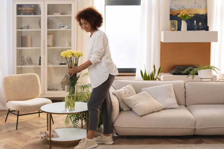 Toronto homeowner preparing living room for home sale with staging | GTA house exterior with improved curb appeal ready to list | Real estate agent reviewing home preparation checklist with seller